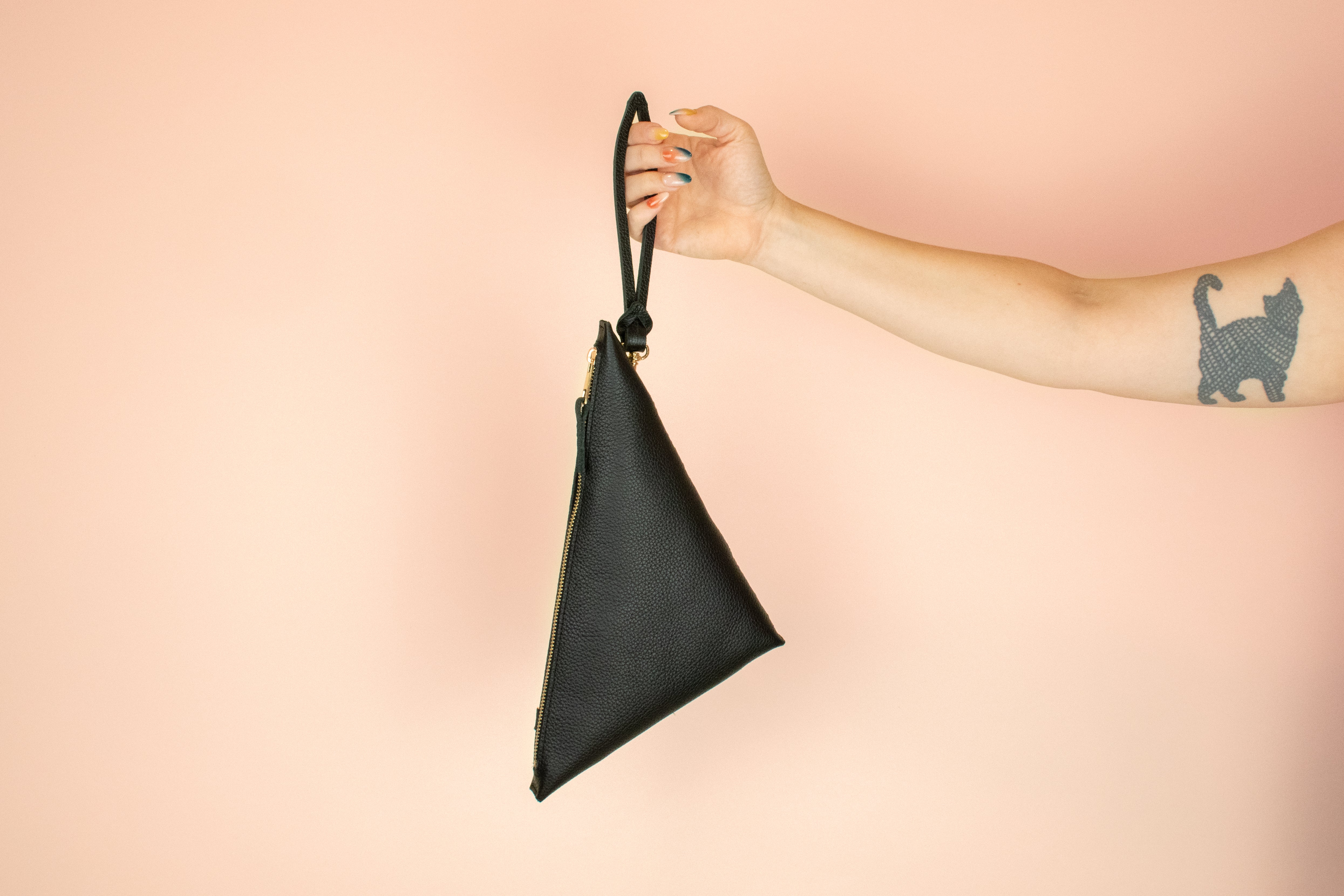 loop keychain attached to black leather crossbody bag