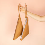 two caramel brown leather wristlets hanging from matching knot keychains