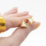 manicured hand holding everyday triangle stud in white terrazo effect