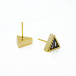 pair of gold geo stud earrings in black stone photographed with one facing post side up and the other camera facing displaying terrazzo design