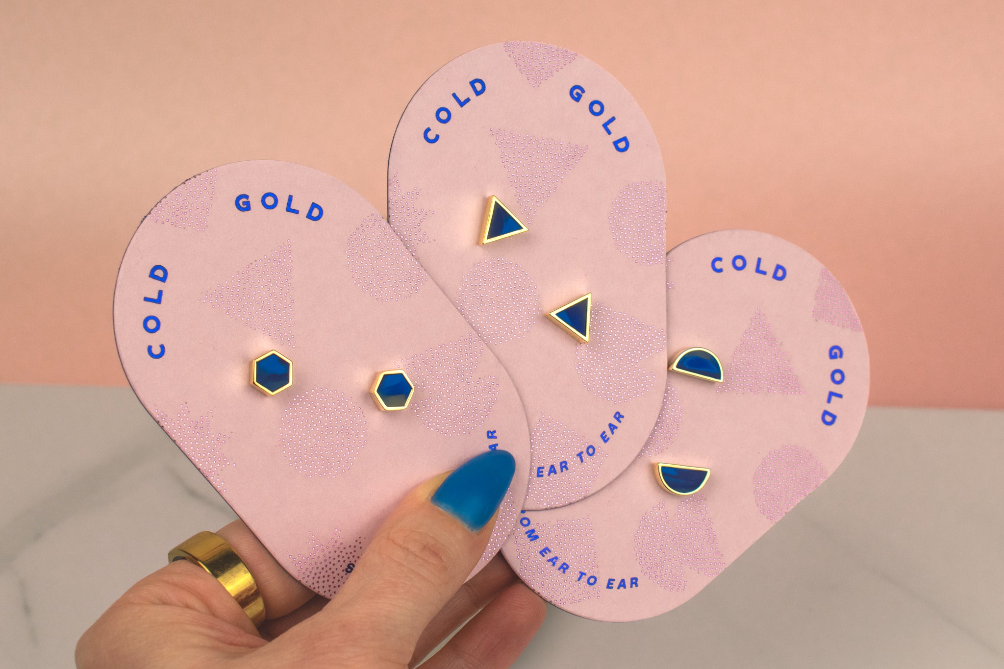 three pairs of sapphire geometric studs in hexagon, triangle, and half moons handmade modern gold plated earrings