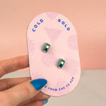 hand holding pink backer card displaying pair of aquamarine handmade clay gold hoop earrings