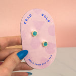 hand holding pink cold gold card with sterling silver and aquamarine marble polymer clay gold simple stud earrings birth stone march jewelry earrings