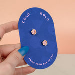 hand holding pair of rose quartz marbled clay handmade minimal earrings