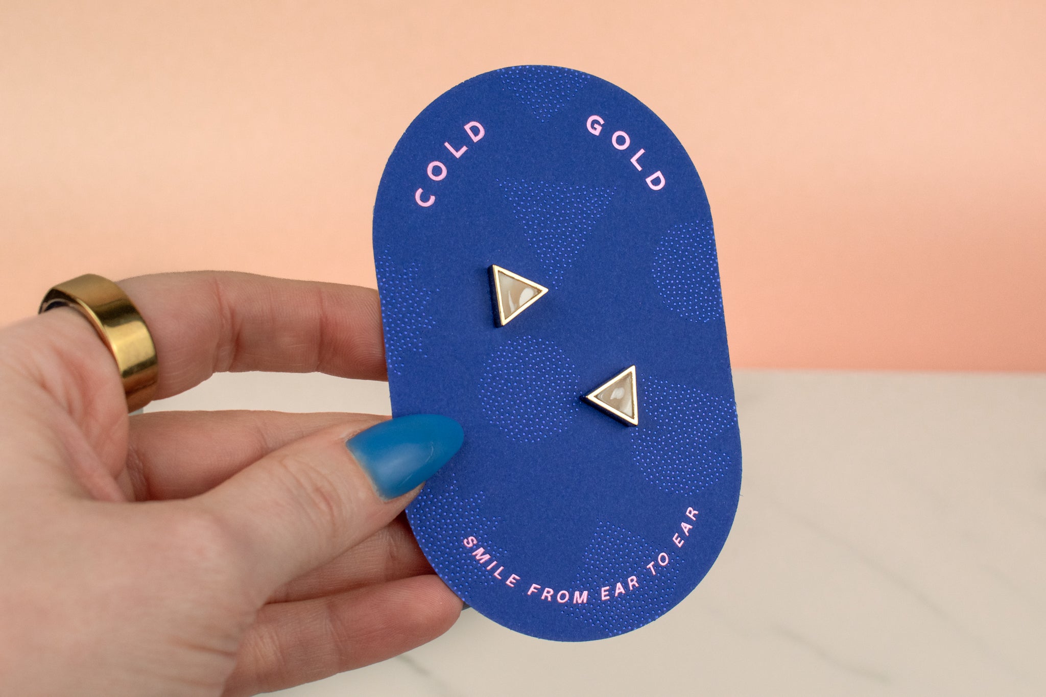 hand holding white quartz handmade 14k gold plated  triangle geometric stud earring set birthday gift gemstone earrings on blue card