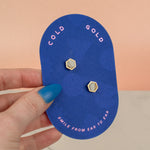 cold gold backer card showing small quartz crystal and gold earring set gold hexagon studs gemstone earrings