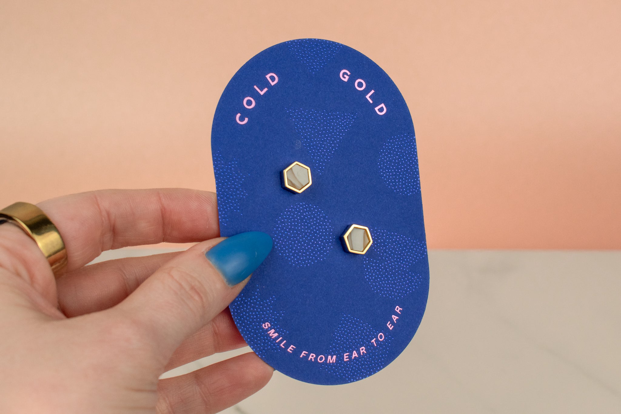 cold gold backer card showing small quartz crystal and gold earring set gold hexagon studs gemstone earrings