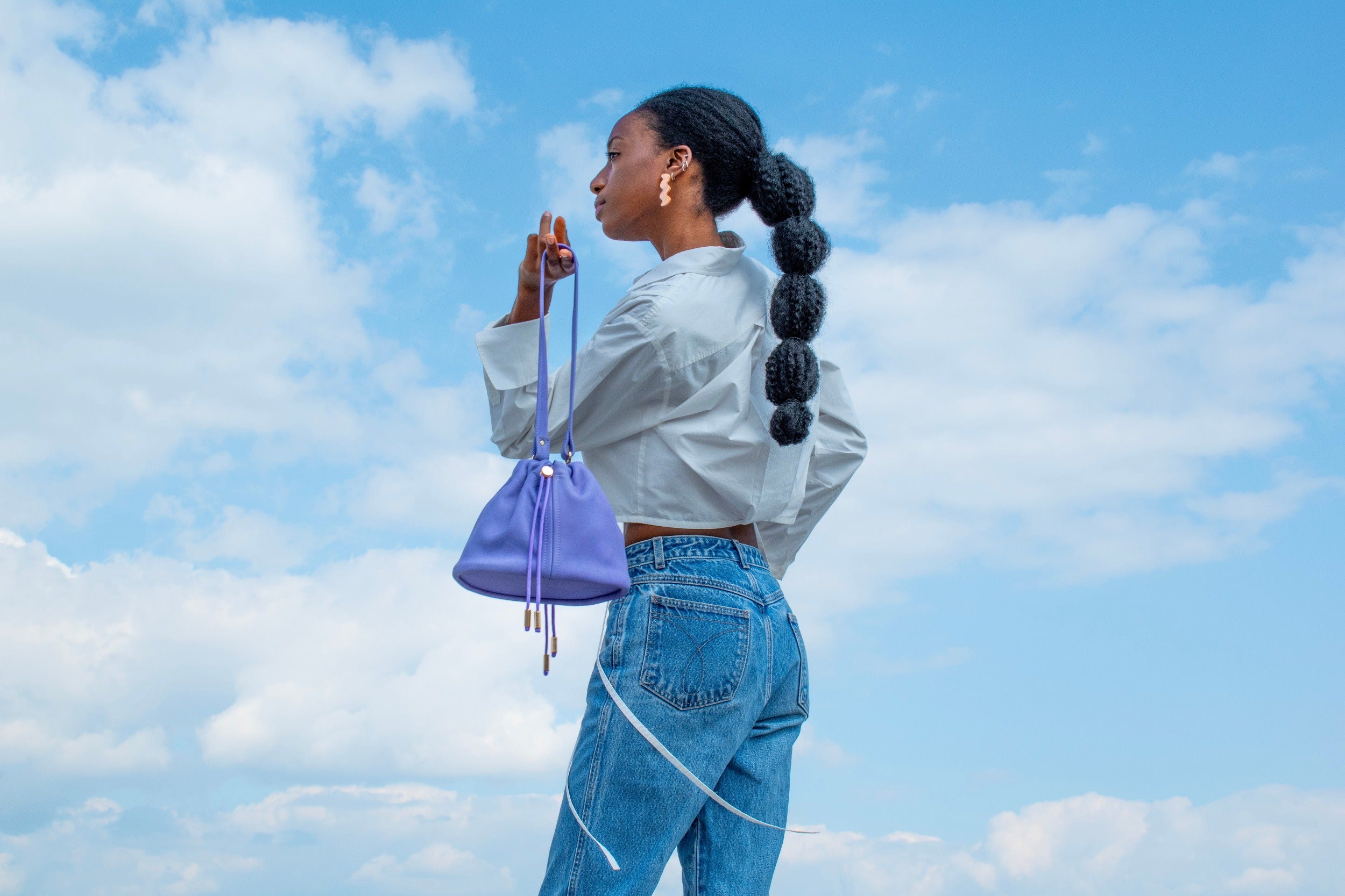 model carrying light purple cute mini leather pouch handbag