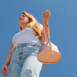 model blue sky background rose gold wristlet pouch bag drawstring closure with gold hardware