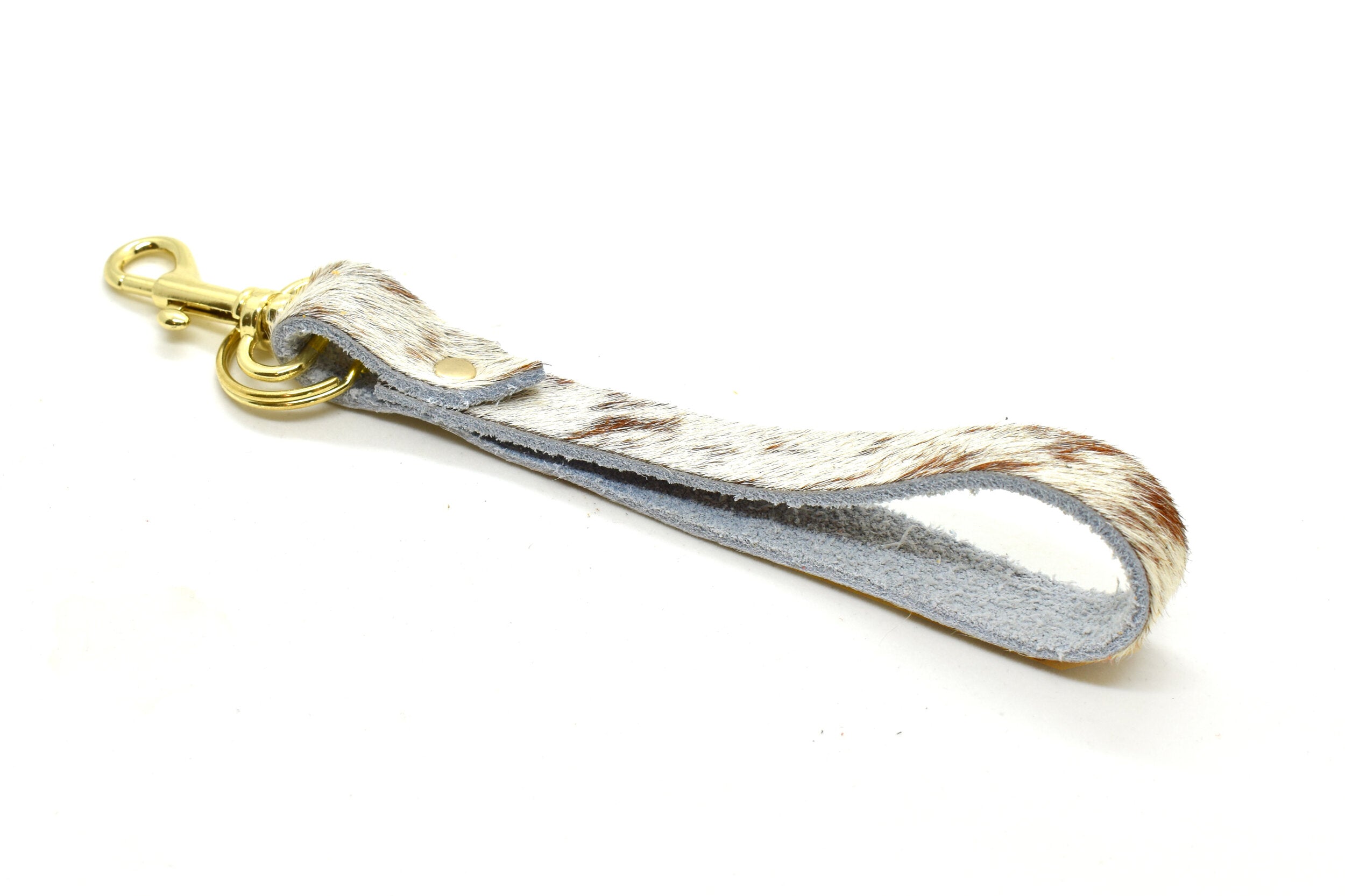 key chain in speckled chestnut leather hair on hide finish with gold key ring and gold clasp.
