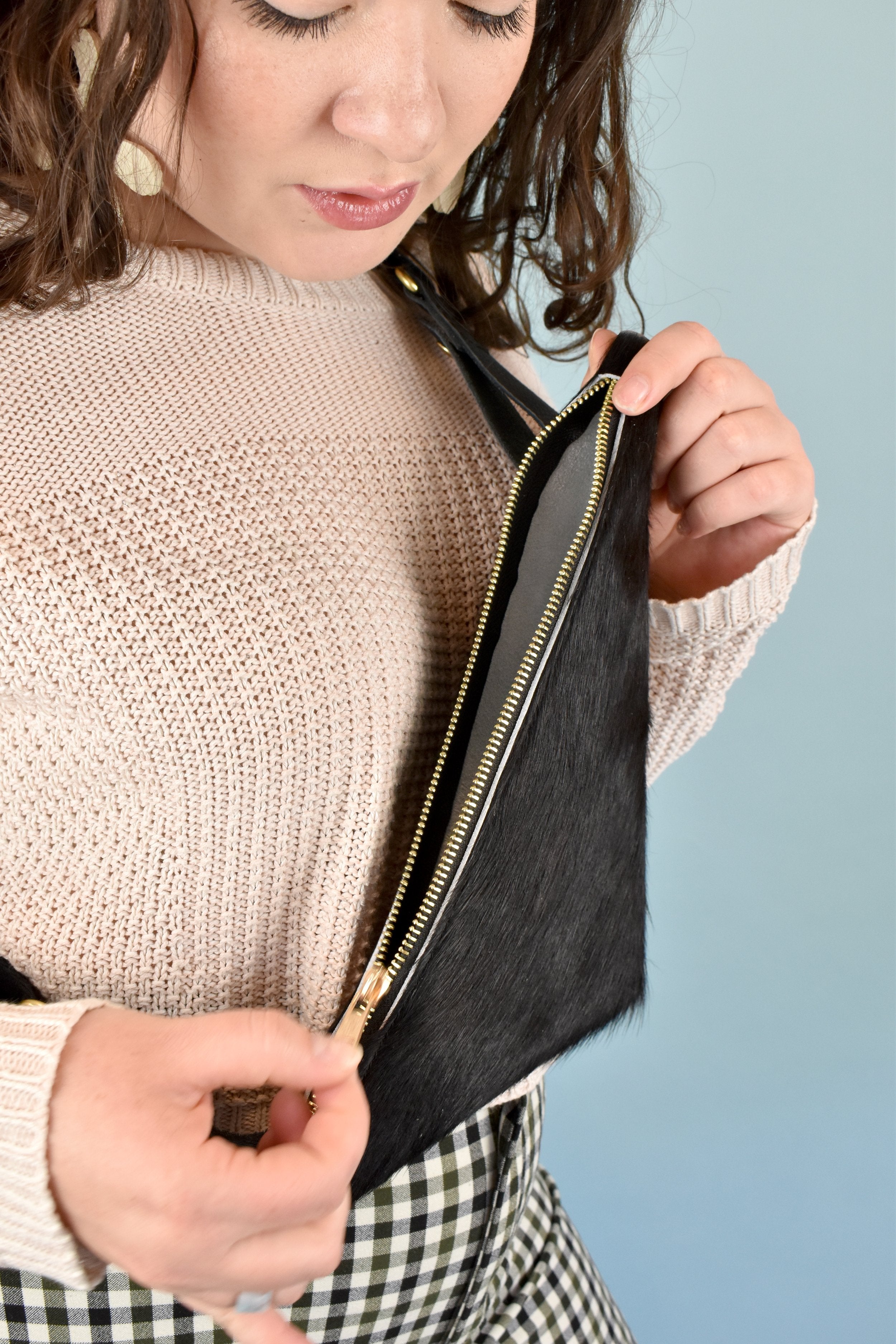 unzipping of black hair on hide western purse