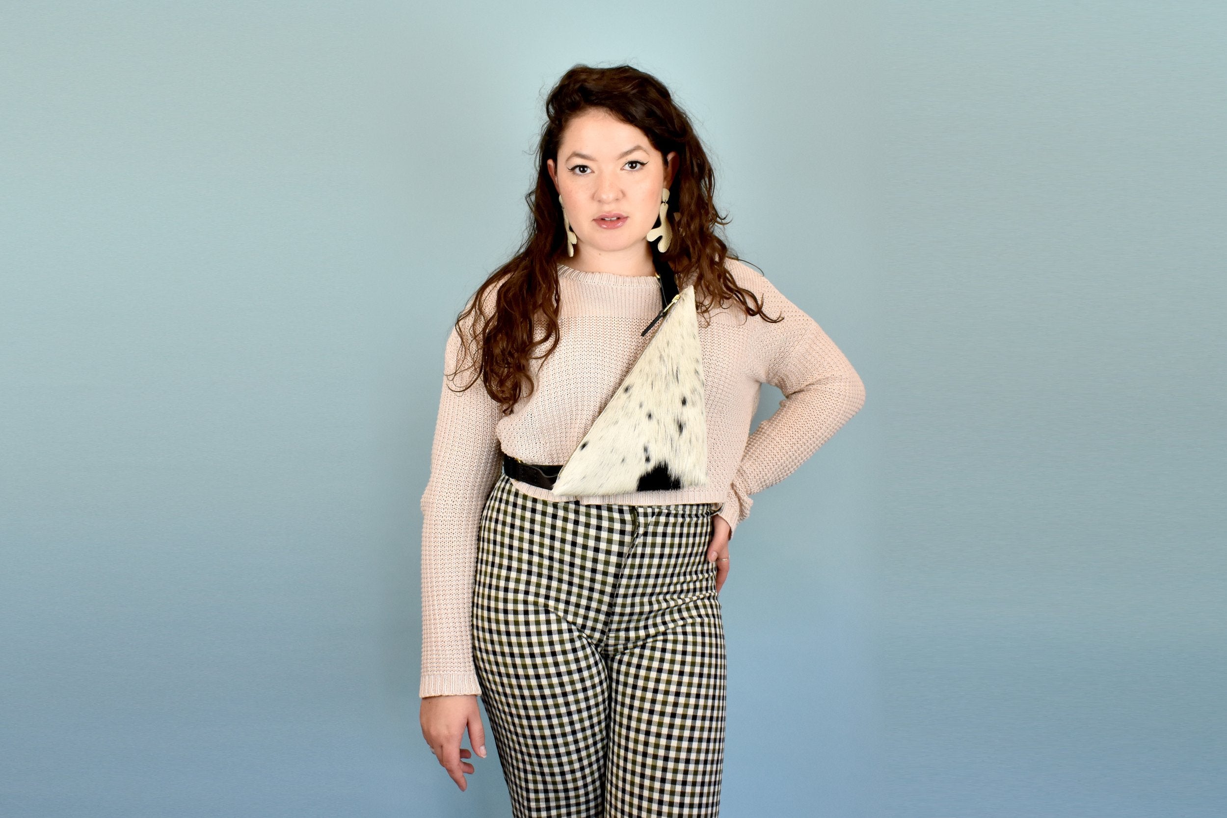 a woman wears a cow print leather purse for music festival essentials bag small leather sling bag crossbody cowhide leather purse cowprint gift for bridesmaids sling bag with inner pocket