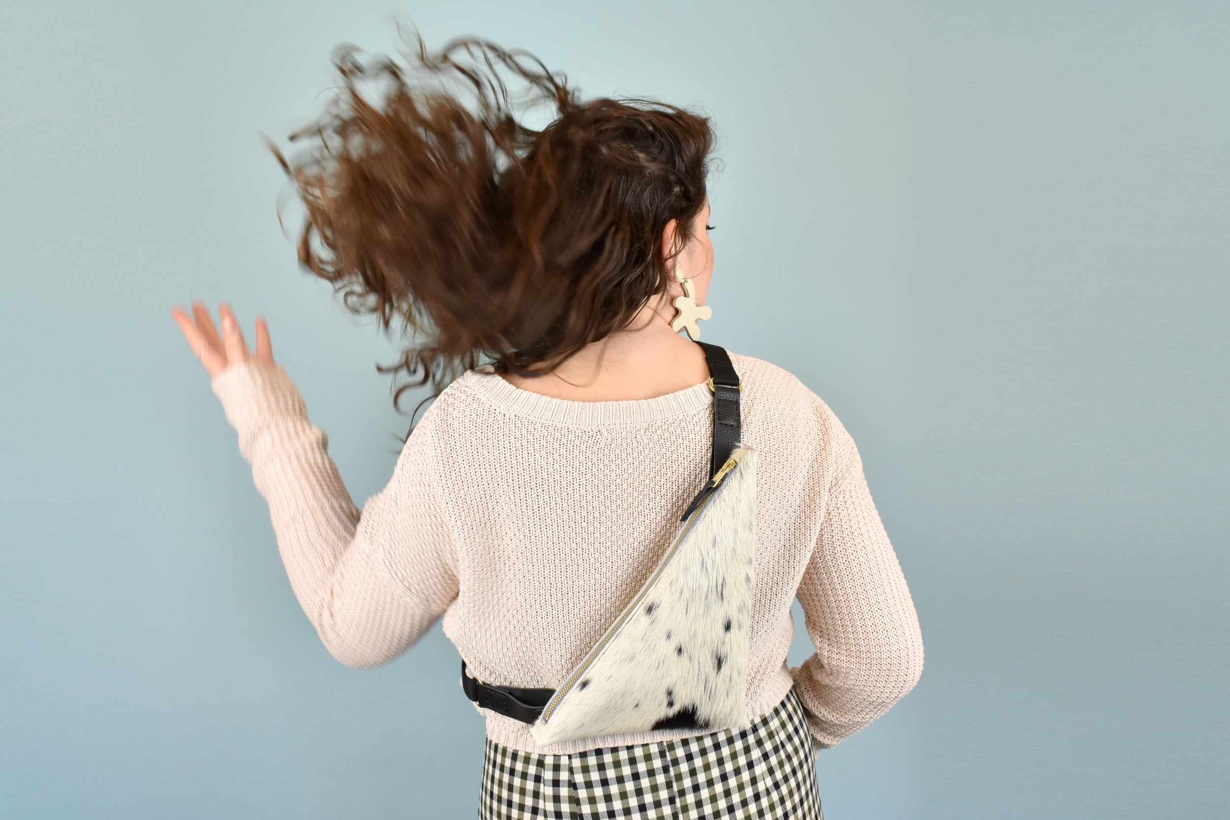 a woman shows off a cowprint bag leather purse for music festival essentials bag small leather sling bag crossbody cowhide leather cowprint gift for bridesmaids sling bag with inner pocket