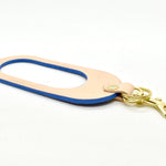 A dual-sided leather multicolor keychain in veg tan leather and saturated Matisse Blue leather