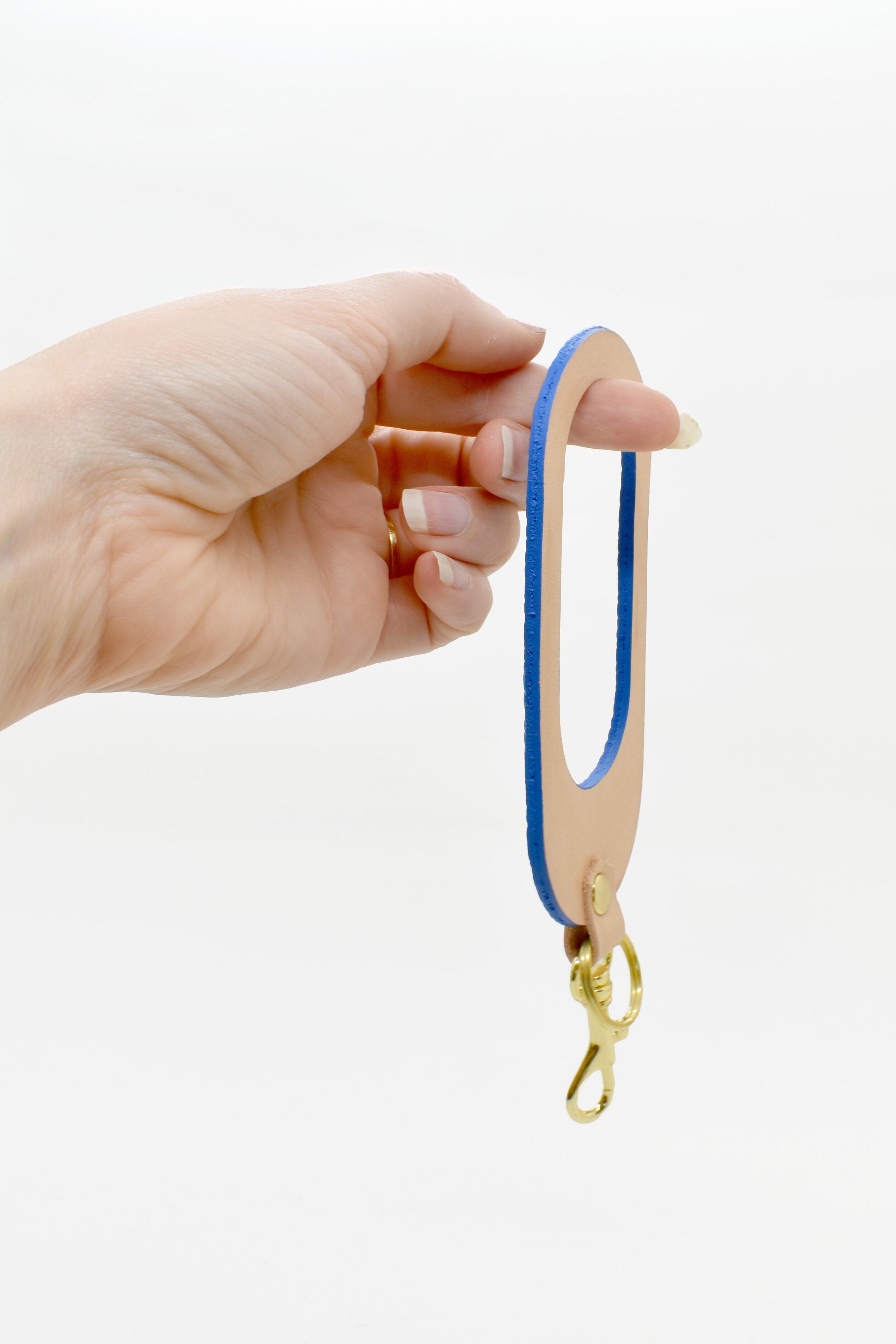 oval shaped leather keychain in royal blue leather and rawhide veg tan leather