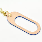 a modern leather keychain with cutout finished with a gold key ring and clasp in vegetable tanned and matisse blue leathers