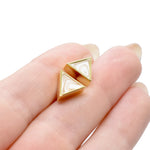 hand holding gold geometric triangle stud earrings white quartz gemstone earrings