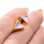 hands holding a pair of marbled amethyst clay and gold plated brass geo stud triangle earrings