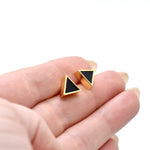 hand holding a pair of gold geometric triangle stud earring set in 14k gold plating good for sensitive ears