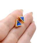 hands holding a pair of geometric triangle stud earrings in matisse blue with gemstone texture clay, hand marbled to look like sapphire, a perfect gift for a September birthday