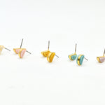 architectural small statement earrings in crystal quartz, rosy pink, golden yellow, aqua blue, and lavender.