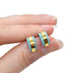 hand holding modern architectural small stud earring set birthstone jewelry march aqua gemstone