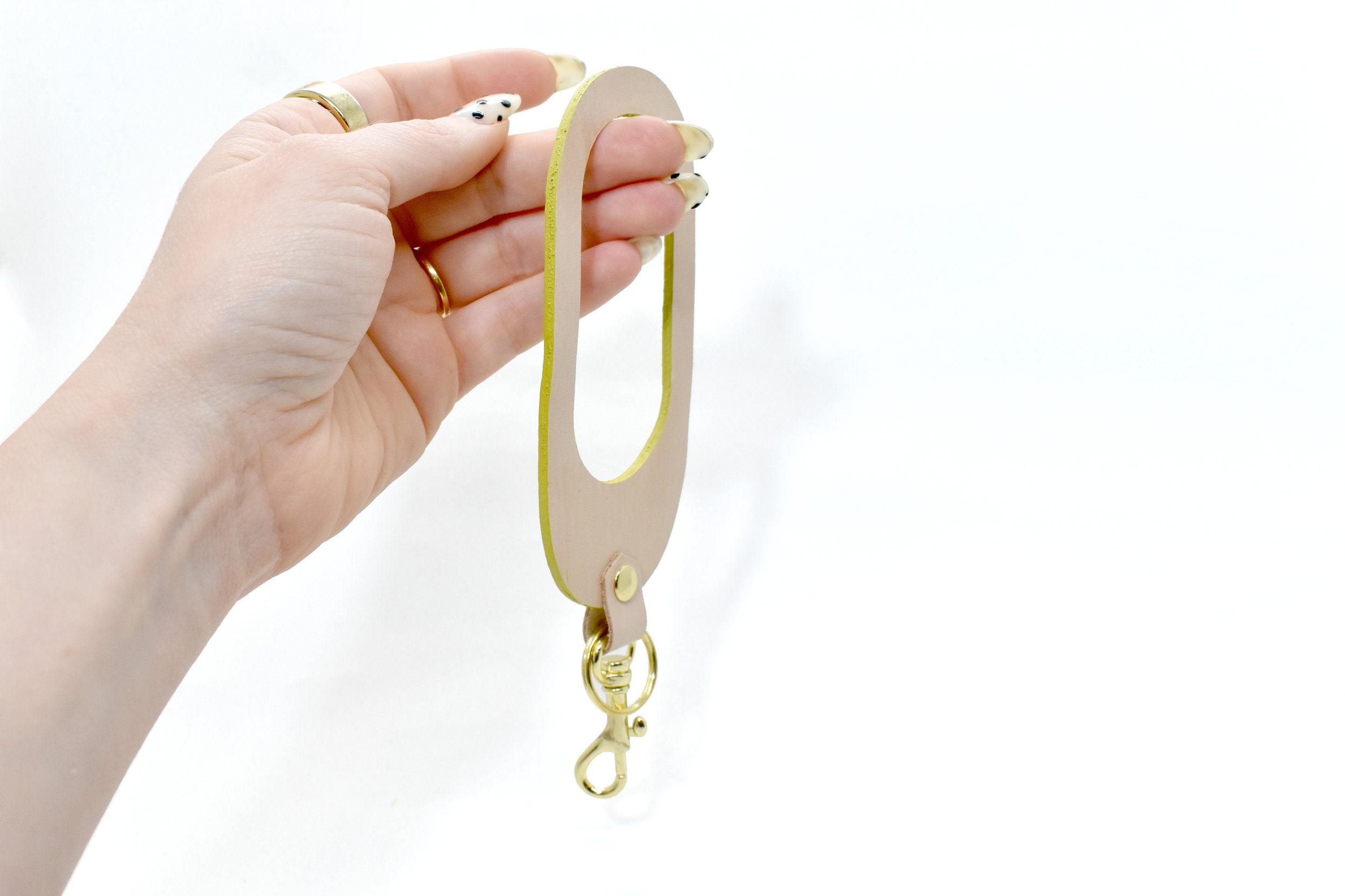 hand holding chartreuse leather wristlet keychain key fob leather modern bold accessory