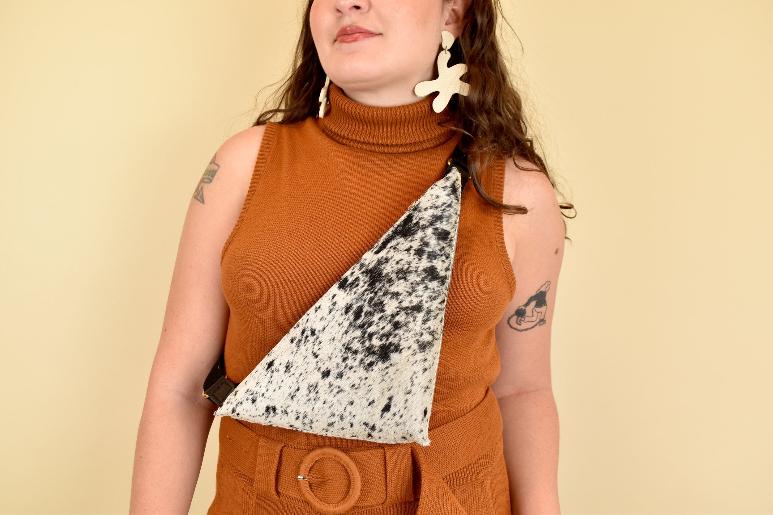 a girl wears a cow sling bag for hiking essentials bag small leather sling bag crossbody cowhide leather purse cowgirl gift for sister in law sling purse with card pocket