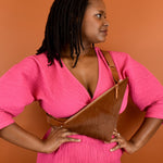 a woman wearing a cowprint crossbody bag cute maximalist accessory minimal leather bag sling gift for bride bridesmaid gift leather sling with inside pocket