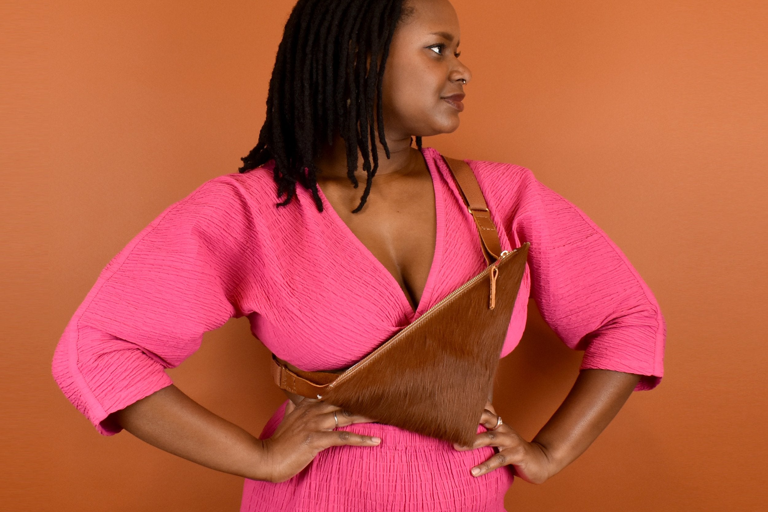 a woman wearing a cowprint crossbody bag cute maximalist accessory minimal leather bag sling gift for bride bridesmaid gift leather sling with inside pocket