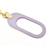 A vegetable tanned rawhide pastel lavender leather keychain with gold clasp hardware