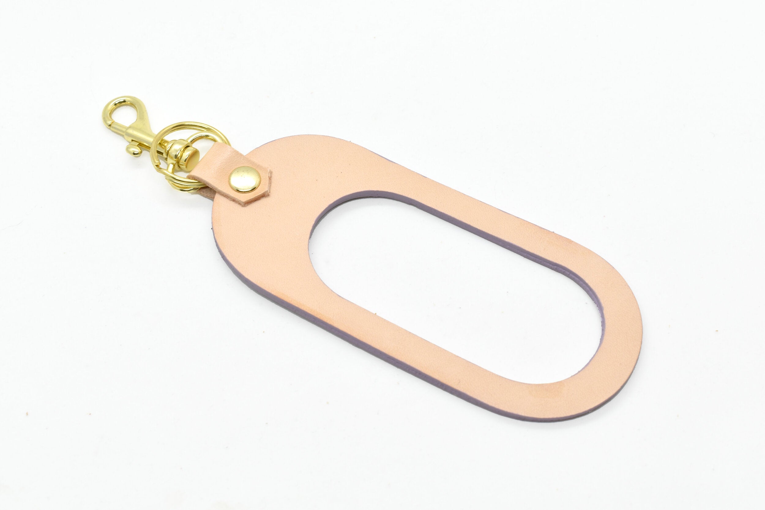 modern leather keychain with cutout finished with a gold key ring and clasp in vegetable tanned and amethyst lavender leathers