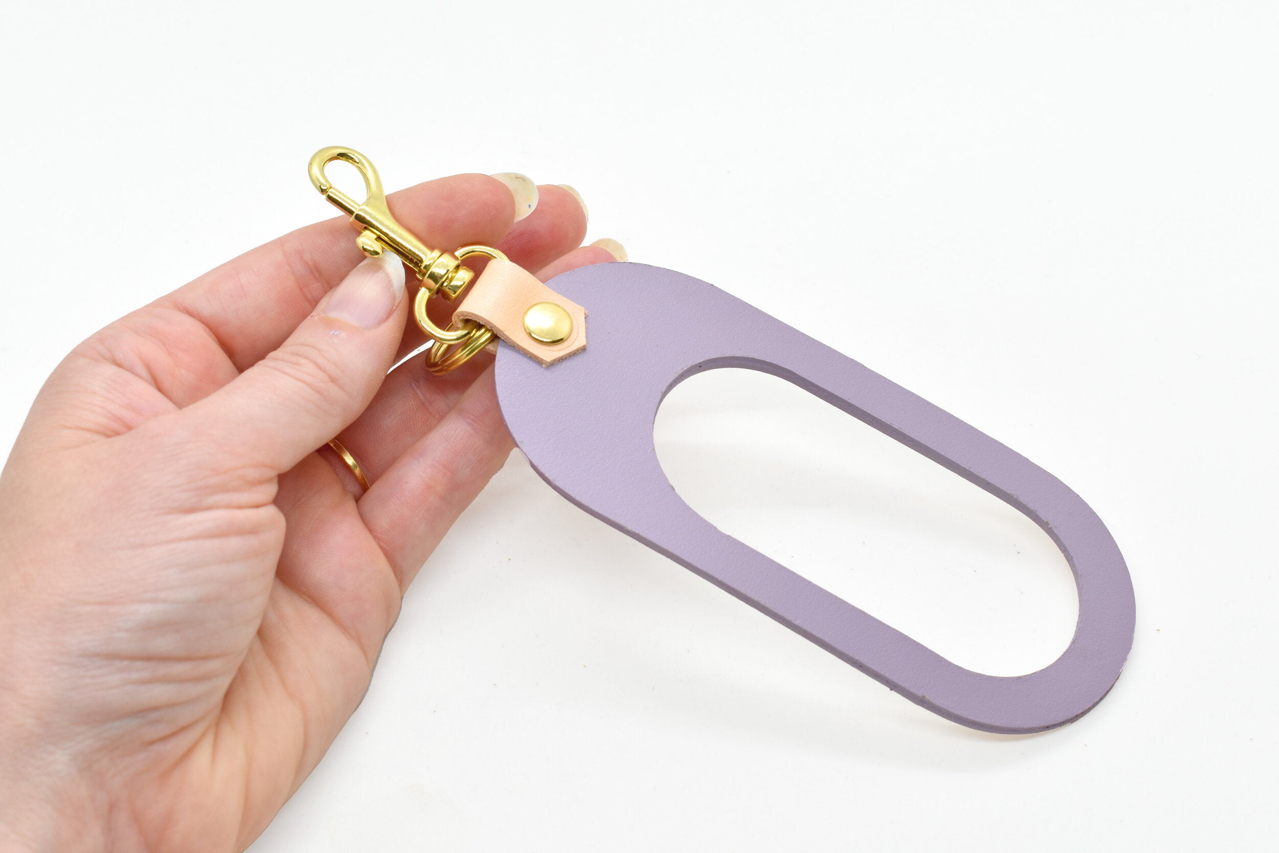 dual-colored leather cut out key chain hand strap with gold keyring and spring clasp in lavender and beige natural authentic leather