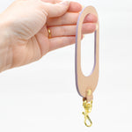 two sided multi color leather keychain with gold key ring and clasp in lavender pastel leather and veg tan leather