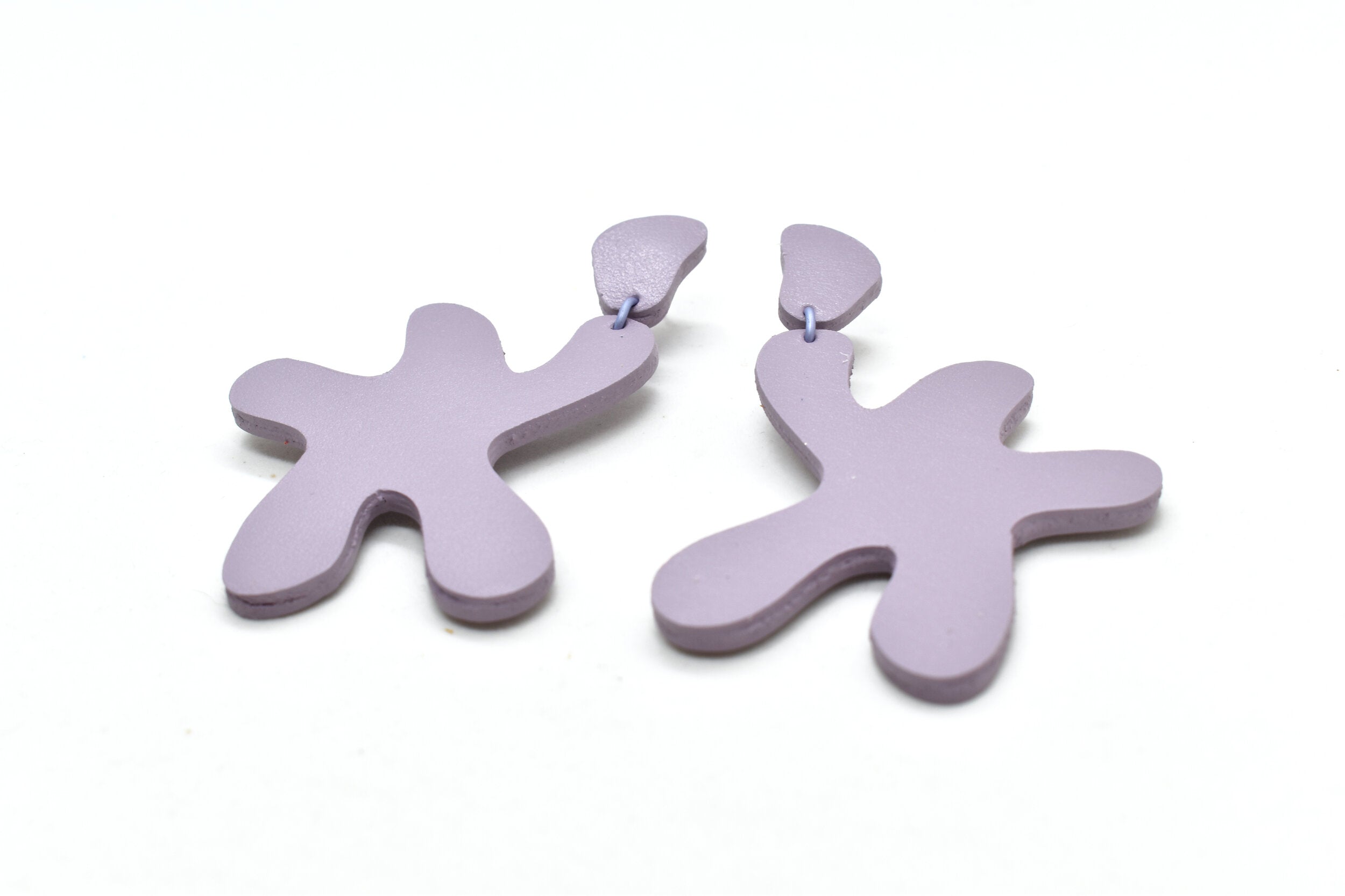 pastel purple leather earrings made of cutout organic shapes and anodized aluminum jump rings.