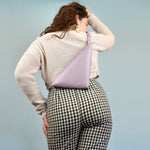 woman shown from the back wearing a small lightweight crossbody bag perfect for trip to park hiking adventure