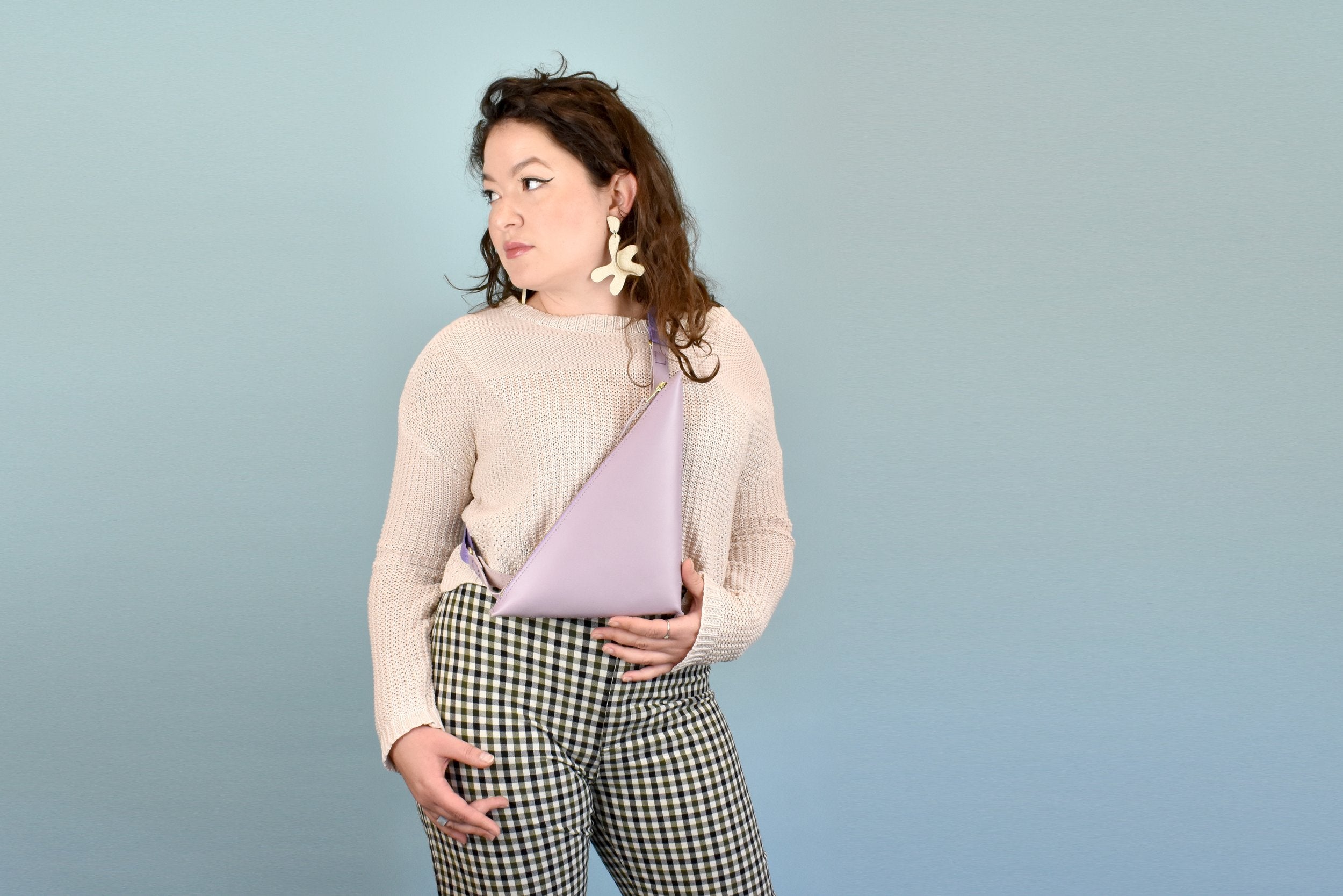 woman wearing leather sling bag purse in crossbody leather bag