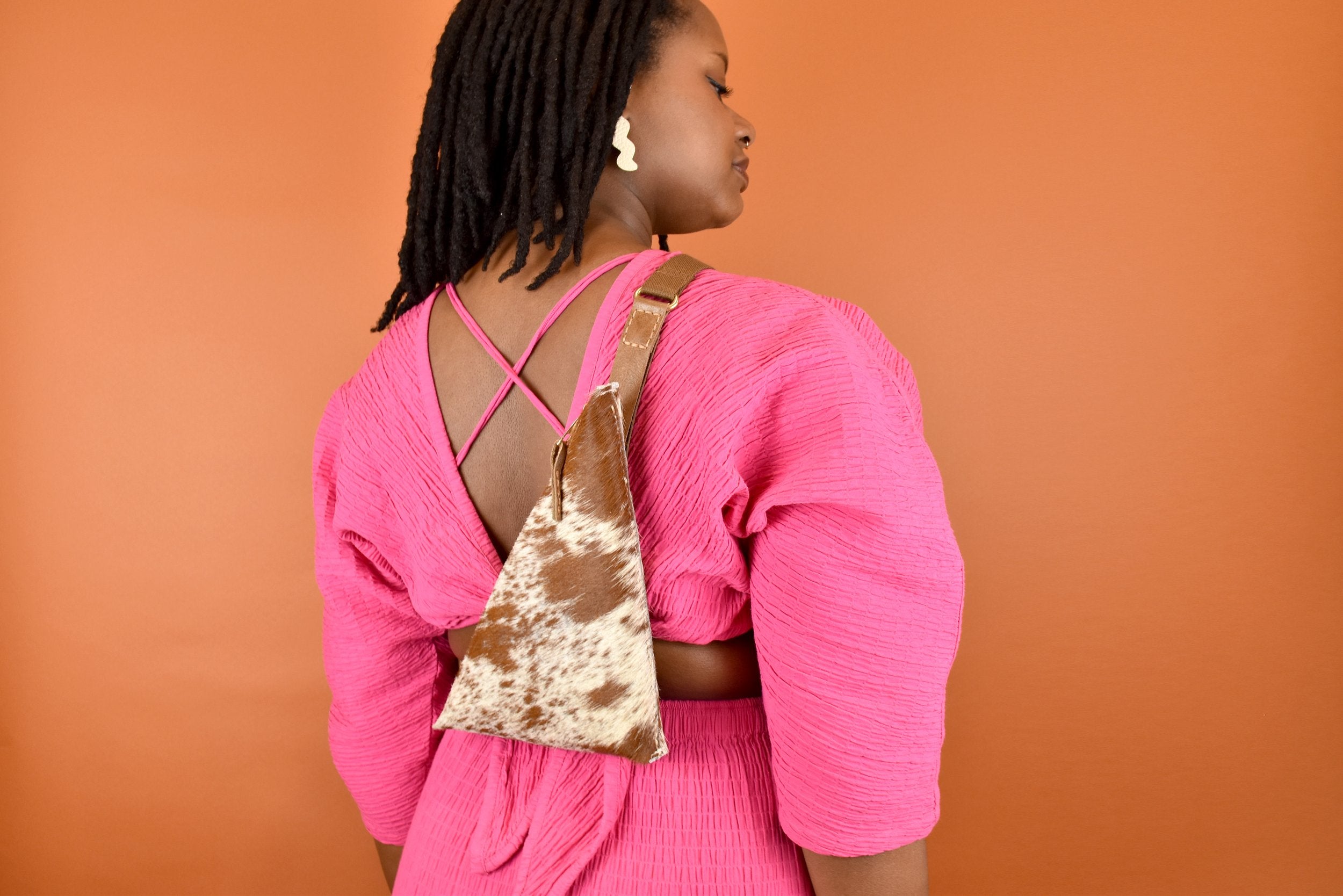 a woman wearing a speckled leather bag trendy accessory minimal sling bag leather gift for sister in law favor for bachelorette party