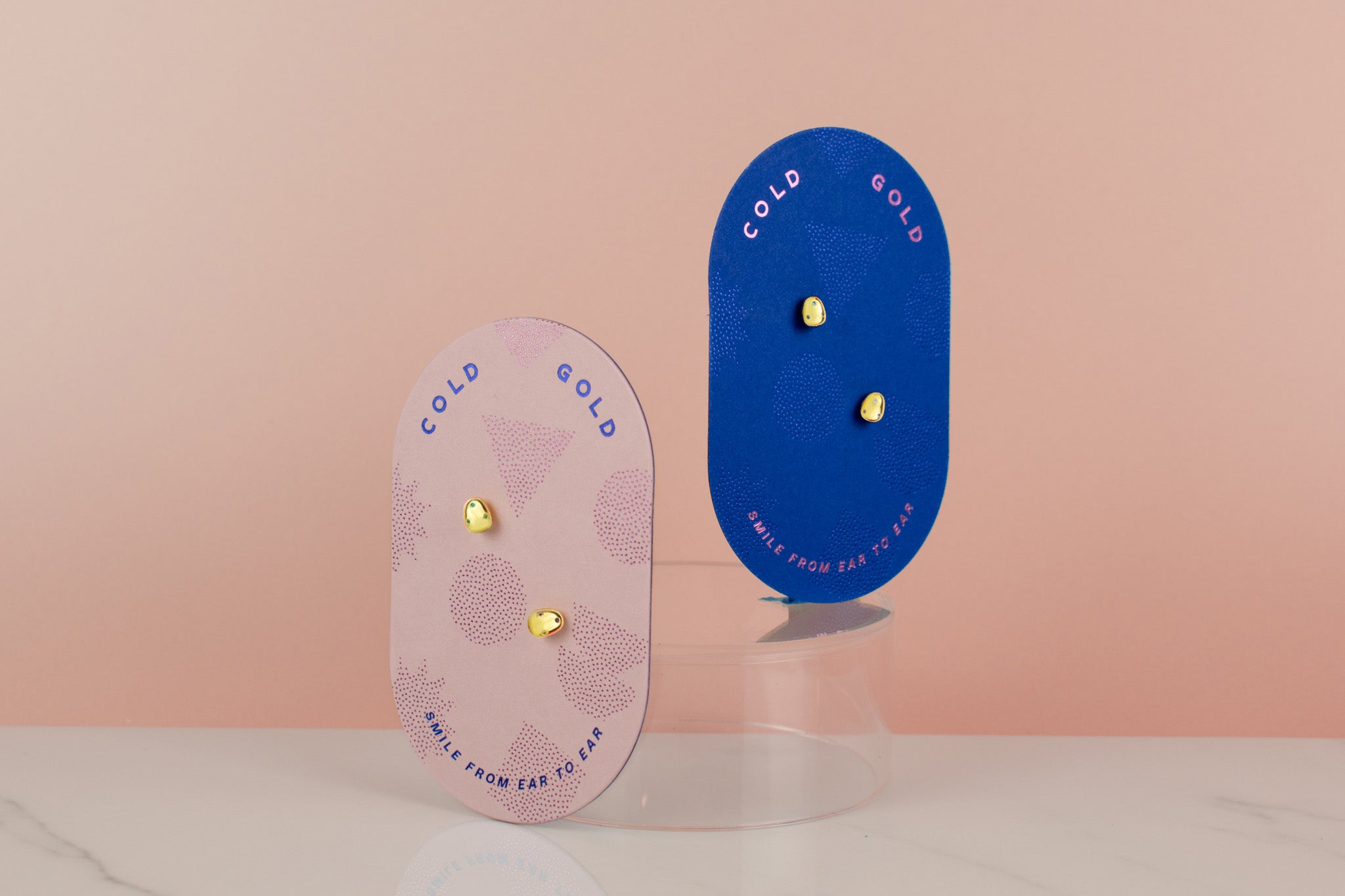 pink and blue cards displaying modern 14k gold plated pearl stud earrings with colorful gemstone inlay