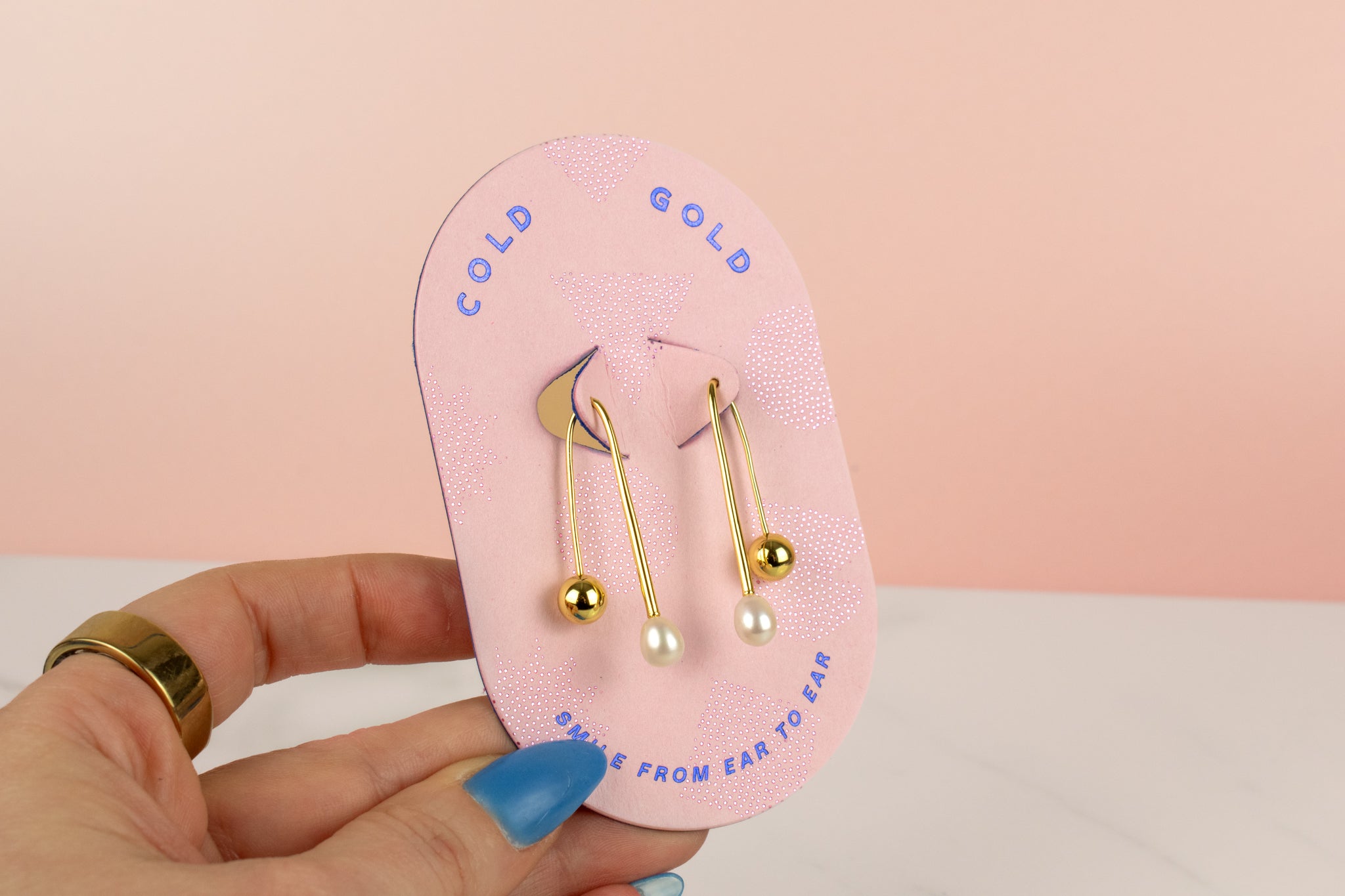 pink card displaying structured threader gold cultured pearl drop earrings