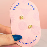 hand holding pink card display baroque pearl gold earrings encrusted with tiny CZ diamonds