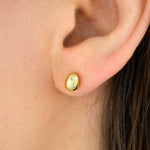 close up of model wearing 14k gold plated baroque pearl earring encrusted with tiny sparkly crystals