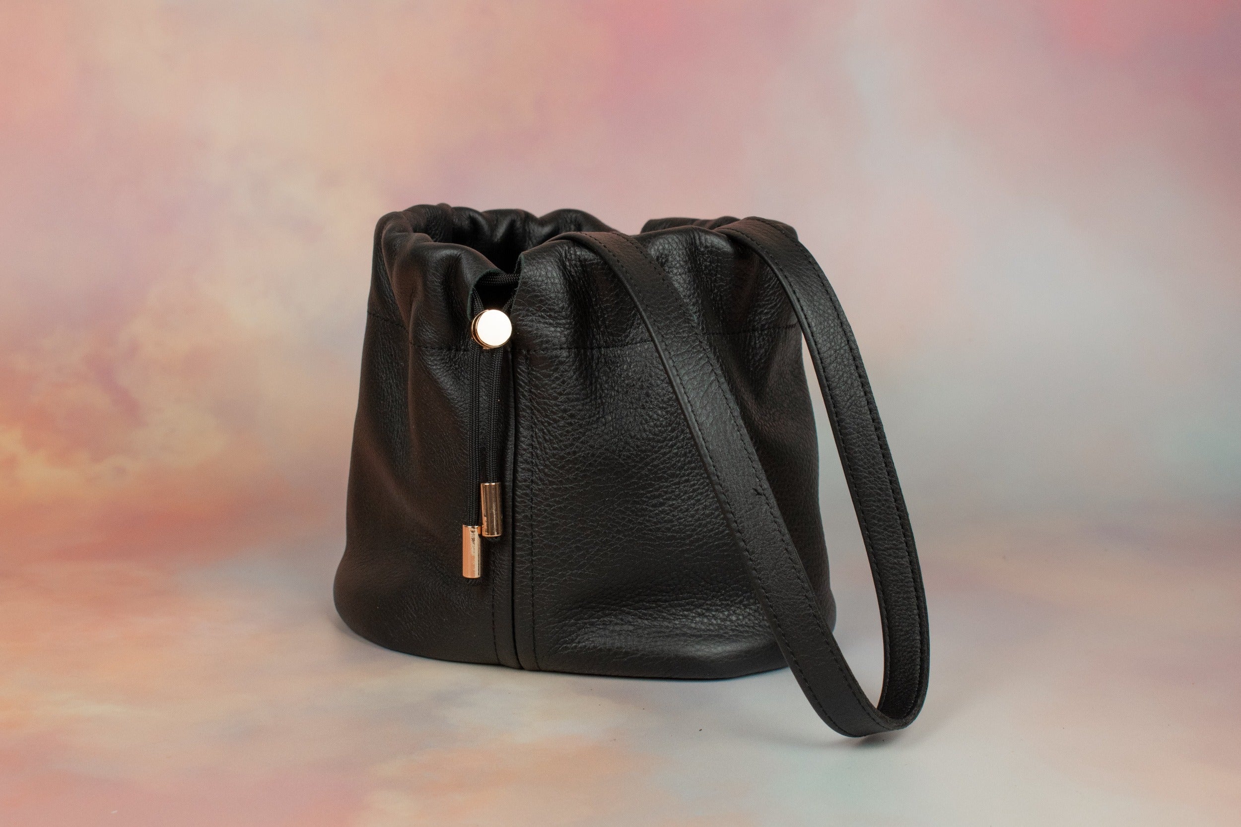 pebbled grain leather bucket bag with drawstring closure and gold hardware