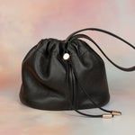 pebbled grain drawstring bucket bag with gold hardware and scrunch top