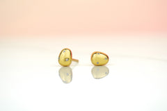 close up of 14k gold plated pearl studs encrusted with crystal gemstones