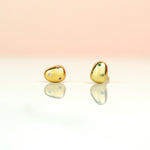 close up of baroque pearl earrings encrusted with micro gemstones in various colors
