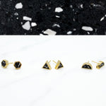 black and white clay terrazzo design gold stud earrings lined up in three different geometric styles: hexagon, triangle, and half moons