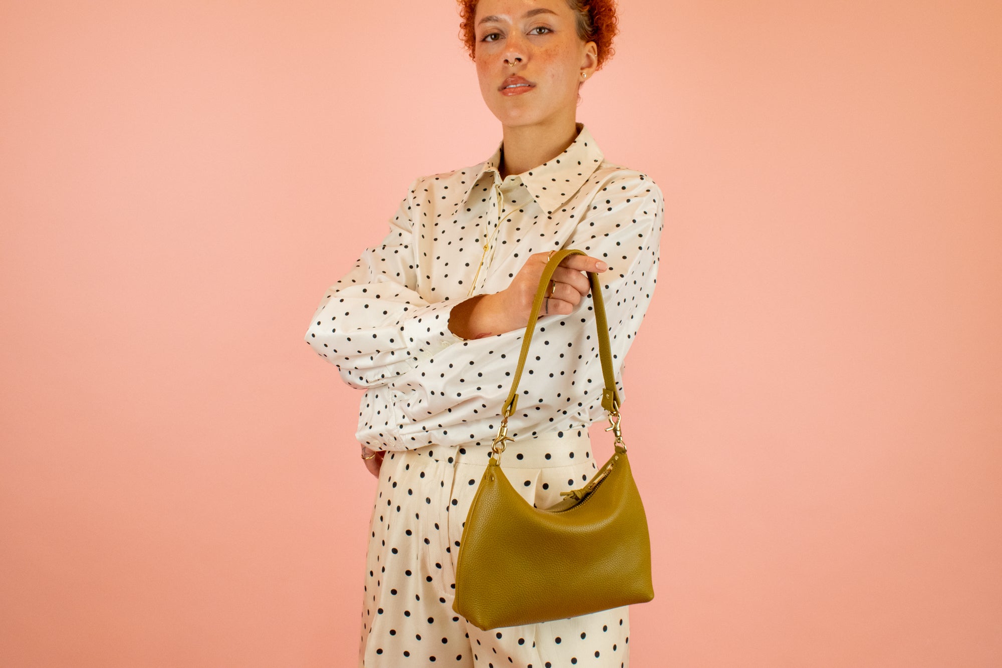 medium sized leather shoulder bag in olive green with detachable strap and gold hardware