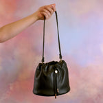 chic black genuine leather drawstring shoulder bag