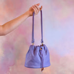 light purple nubuck leather shoulder bag hanging from hand